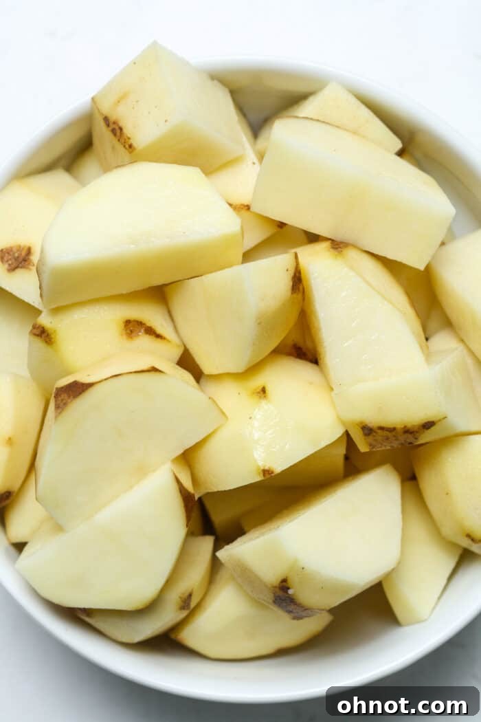 Cubed potatoes in white bowl