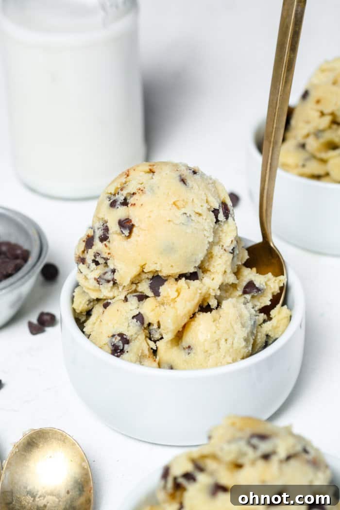 A close-up of delicious gluten-free cookie dough in a white ceramic bowl, ready to be enjoyed.