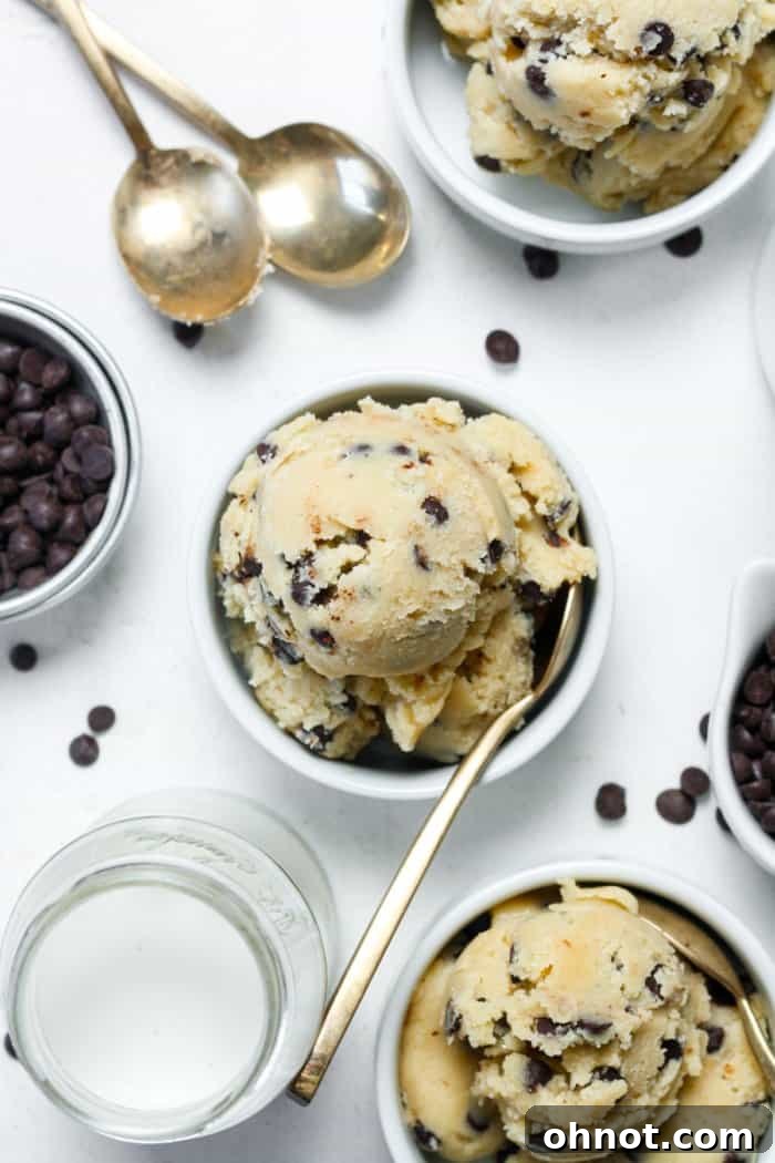 Two white bowls filled with edible gluten-free cookie dough, garnished with extra chocolate chips.