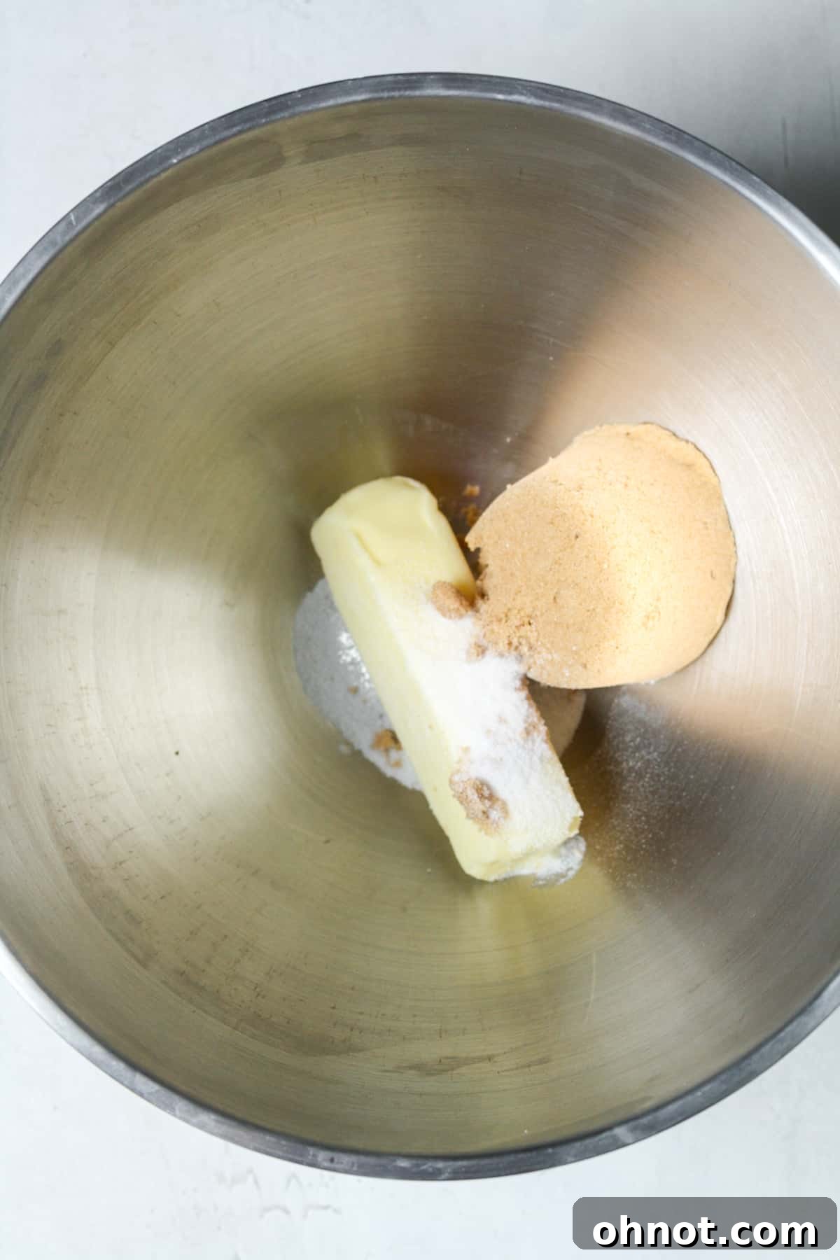 Softened butter, brown sugar, and granulated sugar in a mixing bowl before creaming.