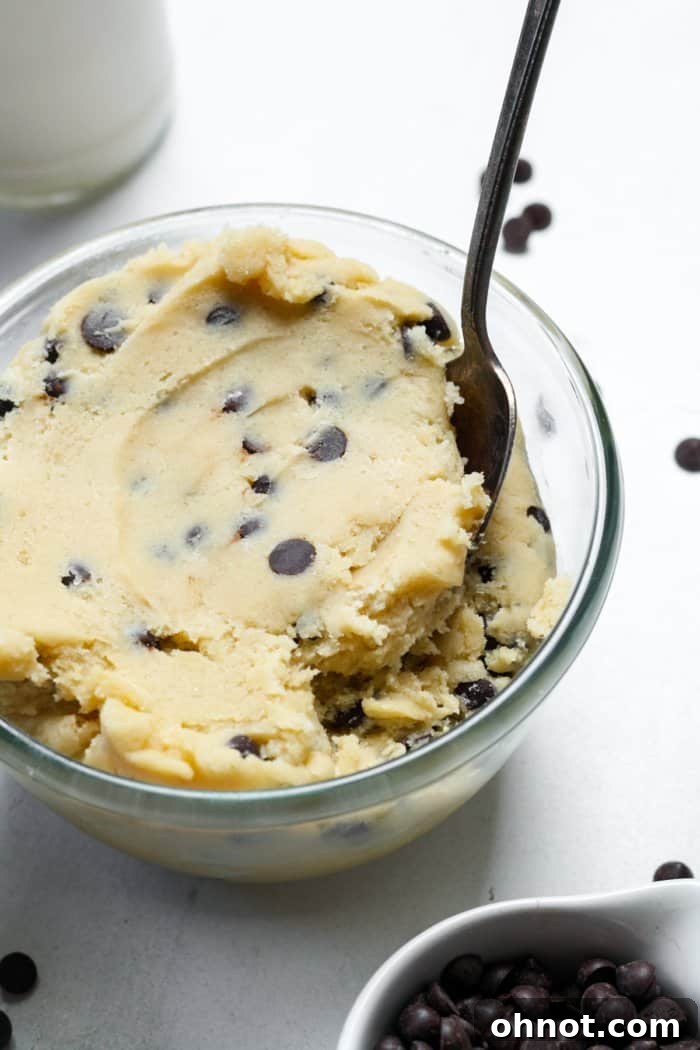 The finished edible gluten-free cookie dough, with mini chocolate chips folded in, presented beautifully in a white bowl.