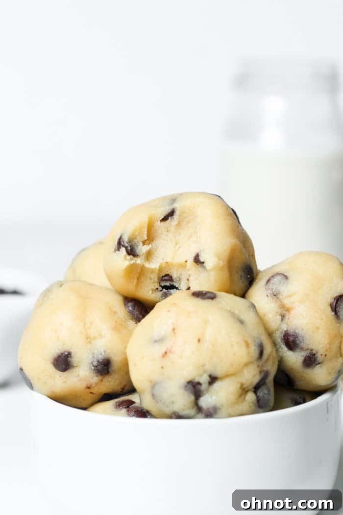 A white bowl brimming with delectable edible cookie dough bites, ready for serving as a delightful treat