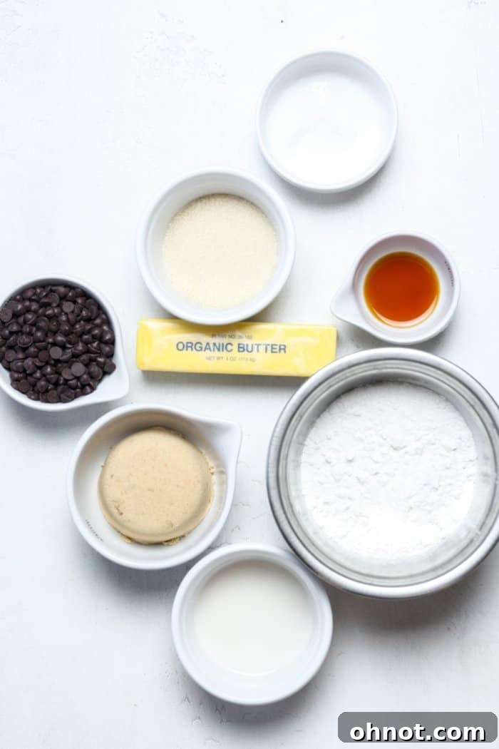 Bowls of raw flour, softened butter, and a blend of brown and granulated sugars, ready to be combined for edible cookie dough