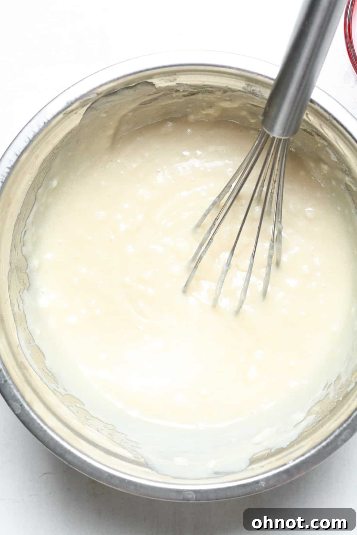 Light yellow cake batter after all ingredients have been mixed.