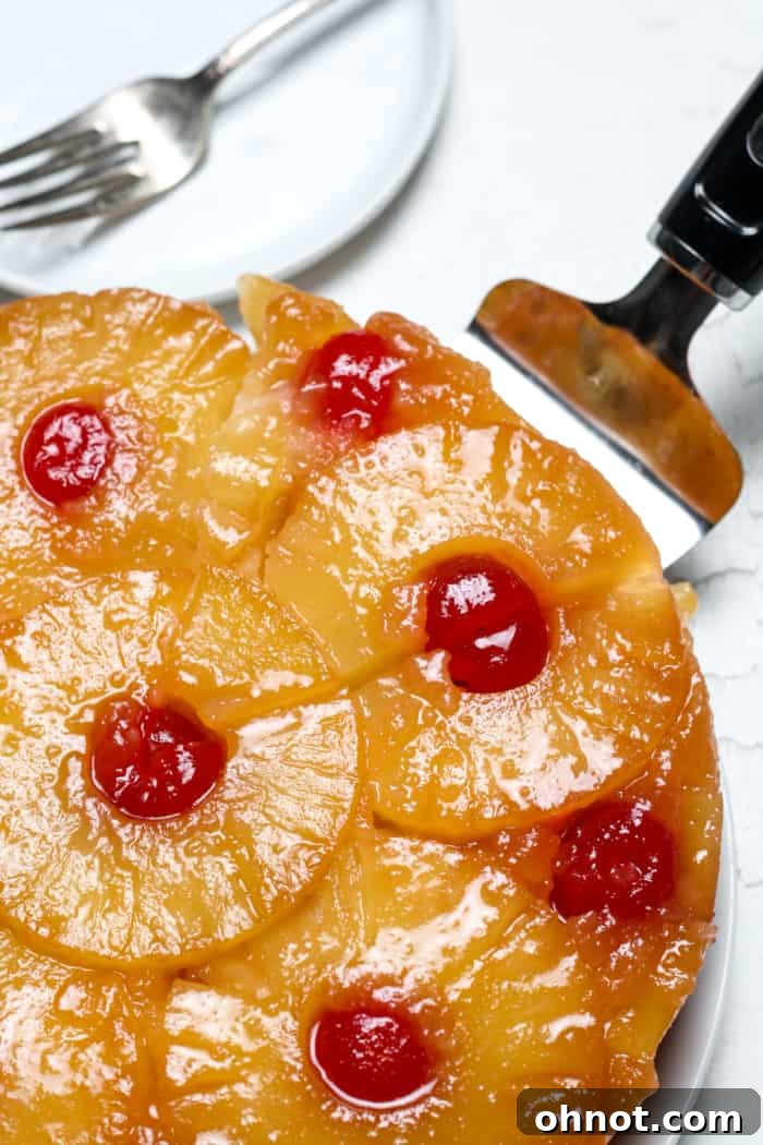 Close-up of a slice of vegan pineapple upside down cake with visible fruit and moist texture.