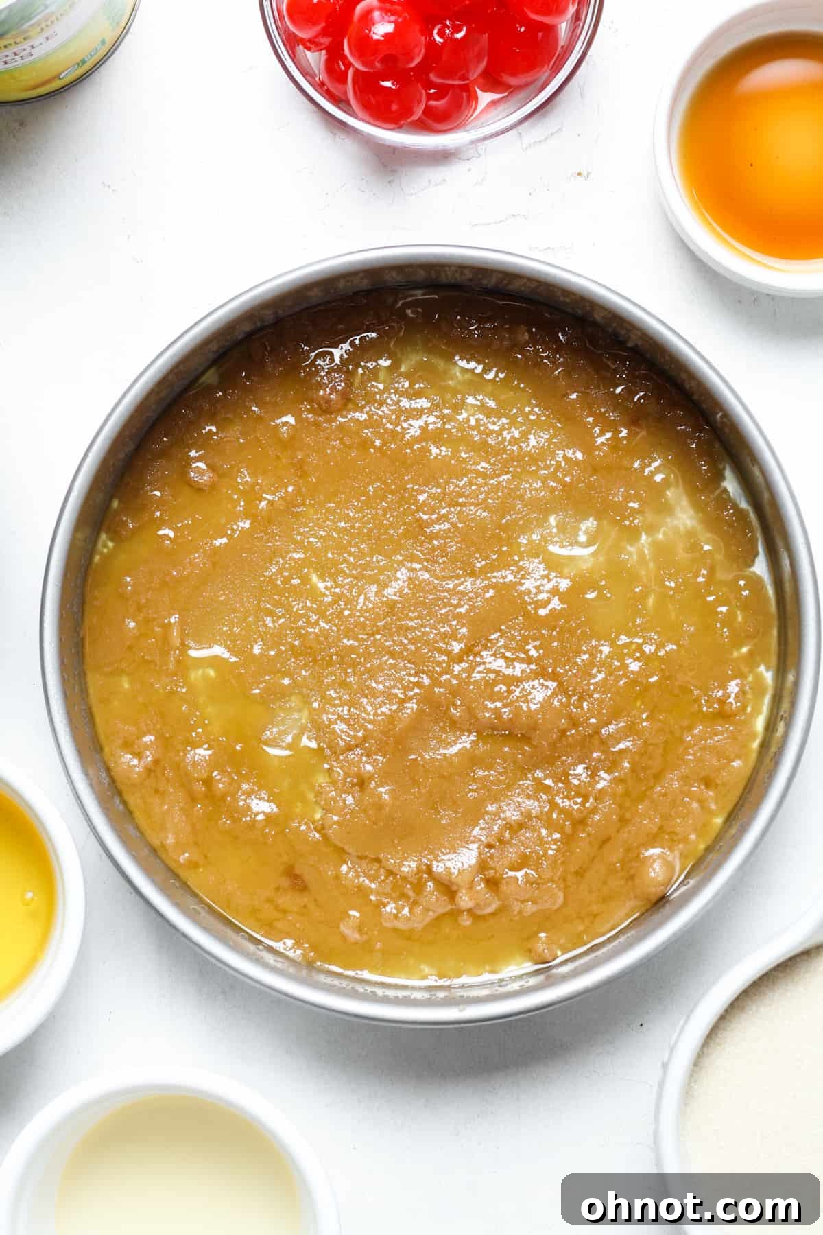 Caramelized topping mixture evenly spread in the bottom of a cake pan.