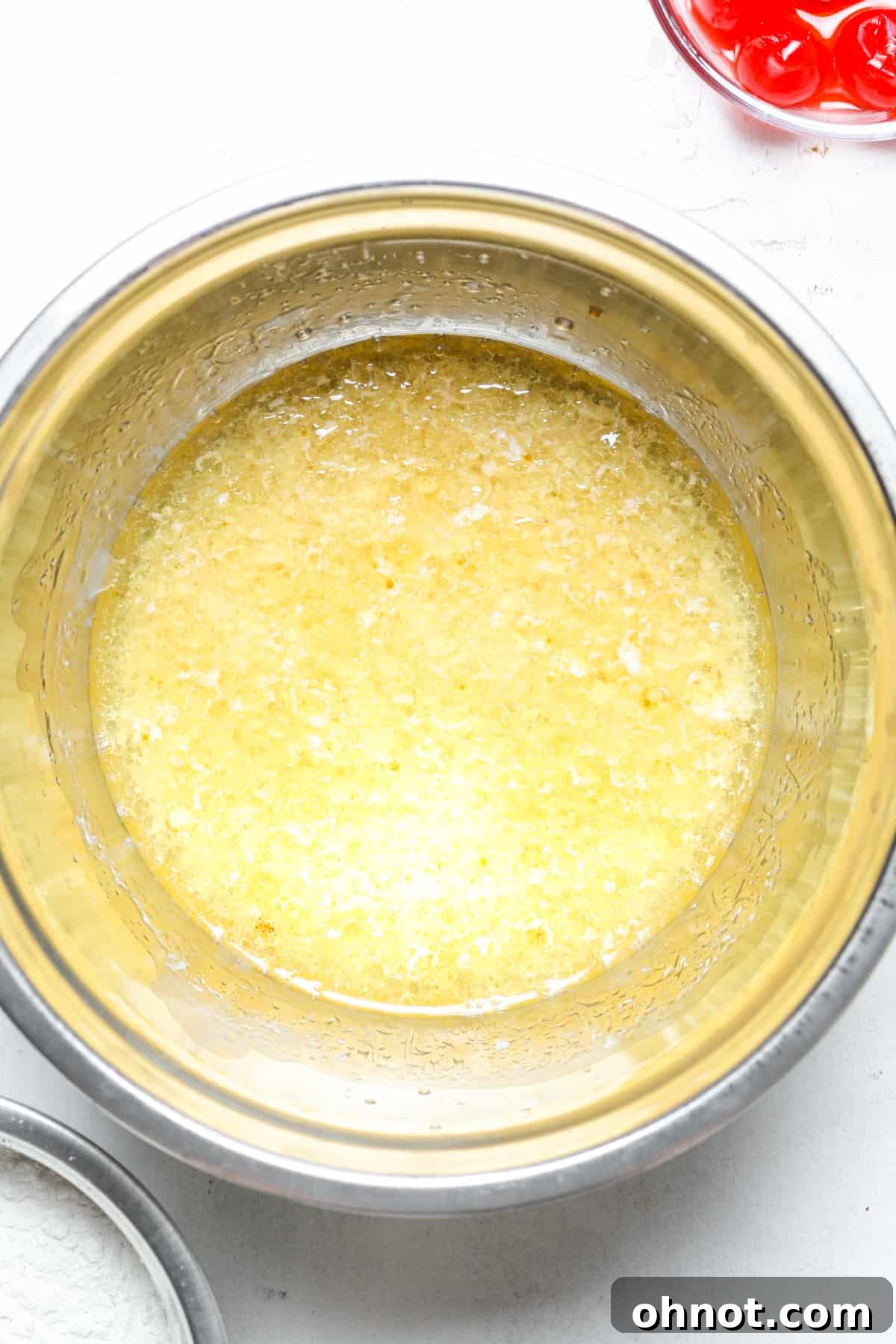 Mixing bowl with combined oil, milk, and vinegar mixture.