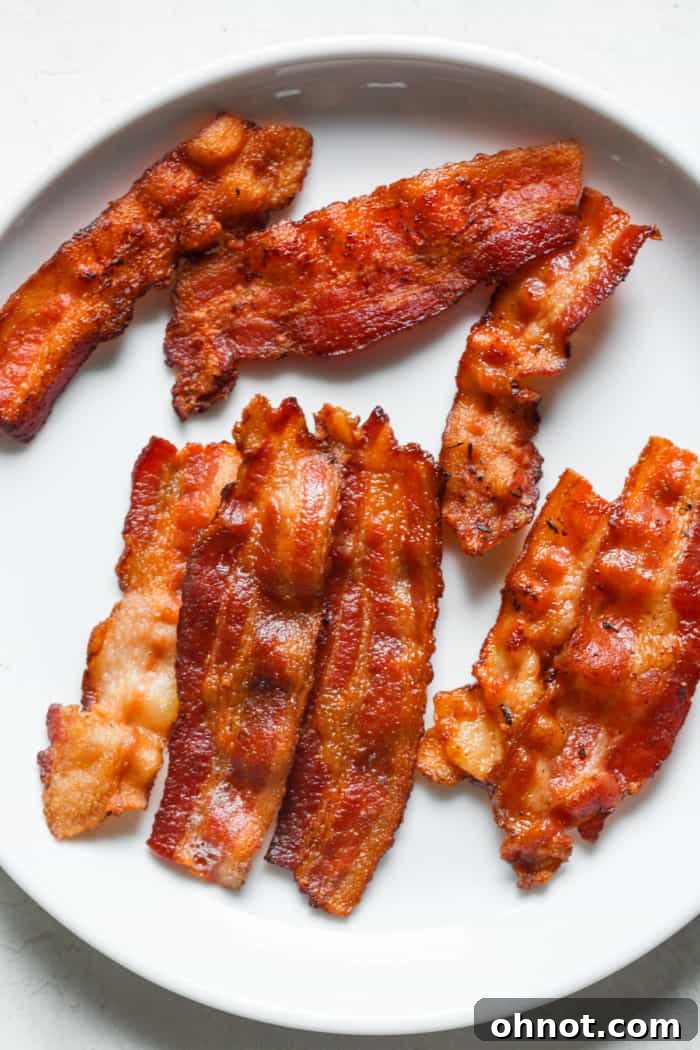 Perfectly crispy Instant Pot bacon on a white plate, ready to be served