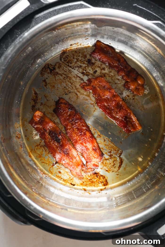 Crispy Instant Pot bacon resting in the Instant Pot