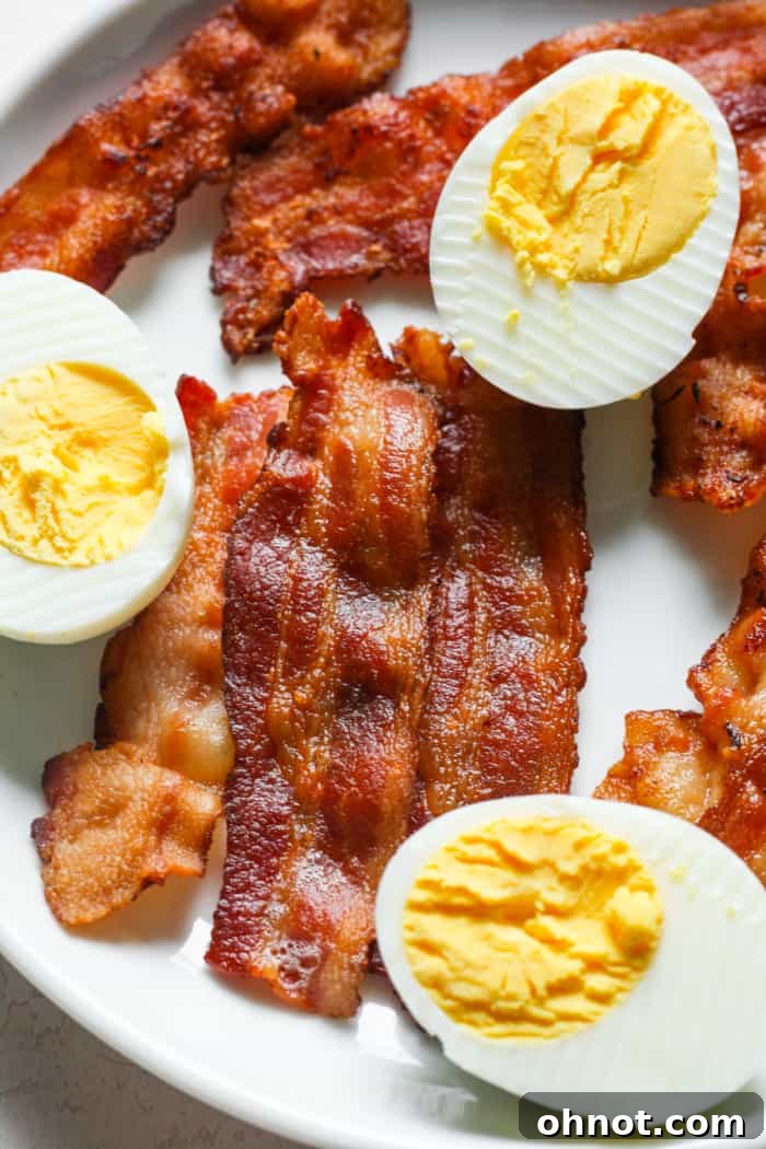 Crispy bacon and hard-boiled eggs on a plate, a healthy breakfast option