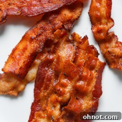 Instant Pot bacon on white plate, garnished and ready