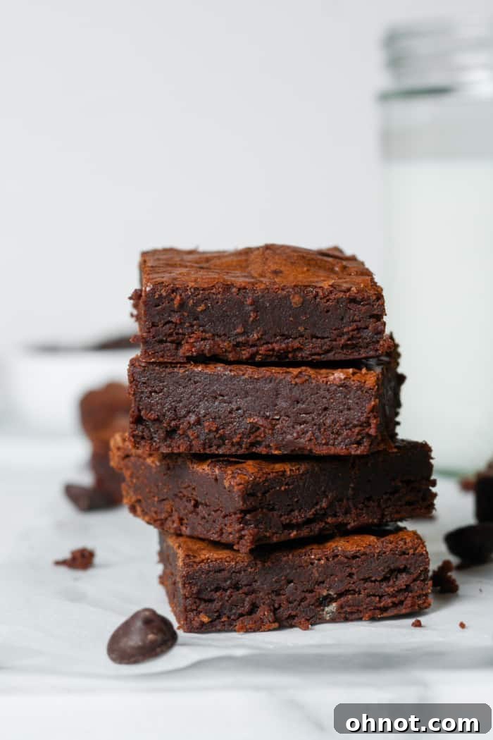 Perfectly baked gluten-free fudge brownies with a rich, dark color and shiny tops
