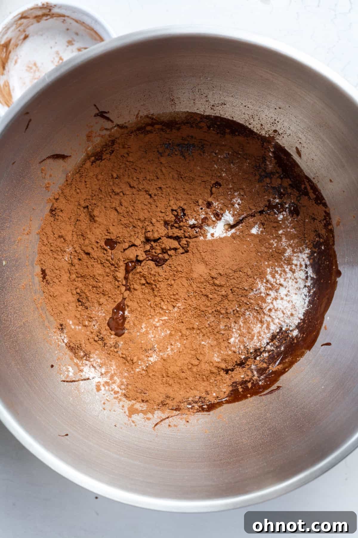 Cocoa powder added to the wet ingredients in the bowl