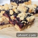 Paleo Blueberry Crumb Bar on a sheet of beige parchment paper.