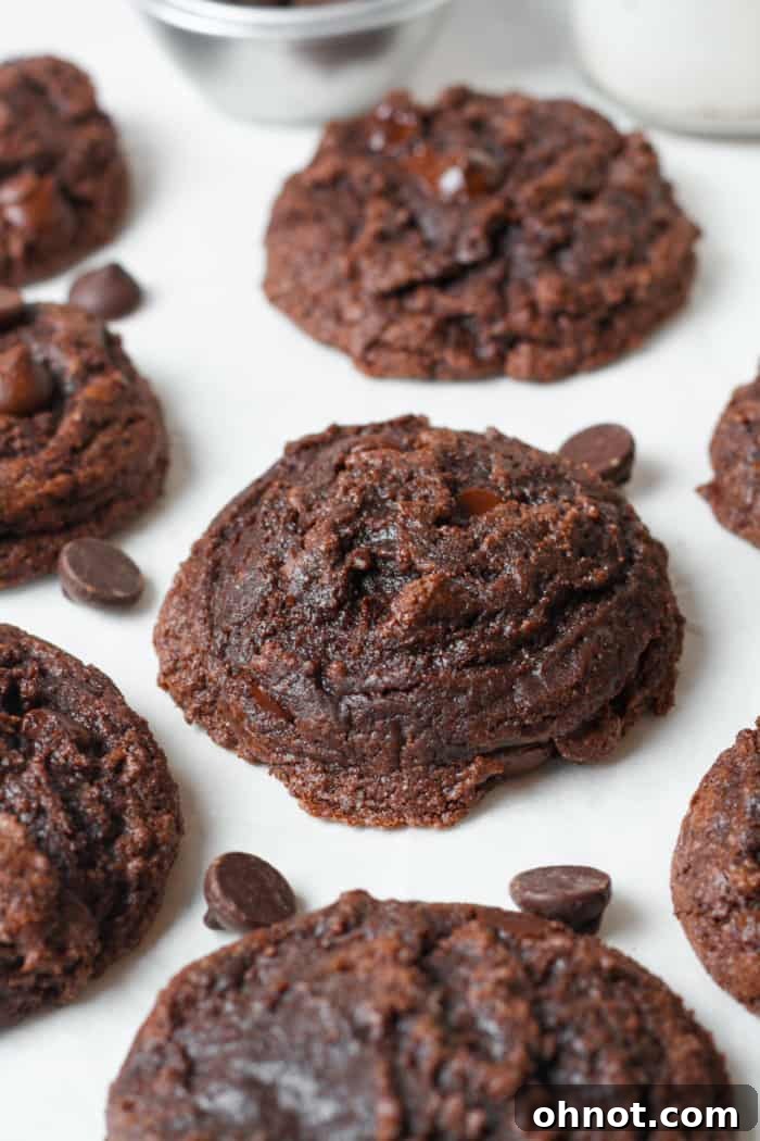 A stack of thick, double chocolate brownie cookies, highlighting their rich color and inviting texture.