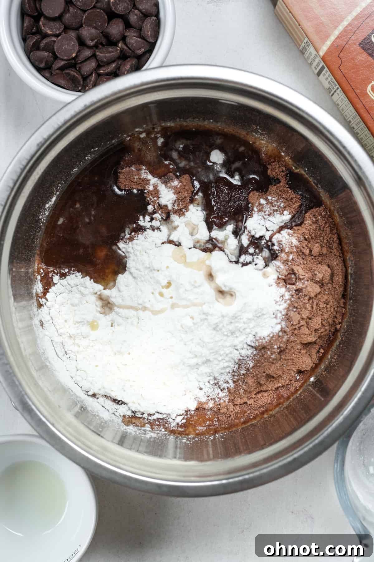 All brownie cookie ingredients – mix, flour, oil, and vanilla – gathered in a mixing bowl before stirring.