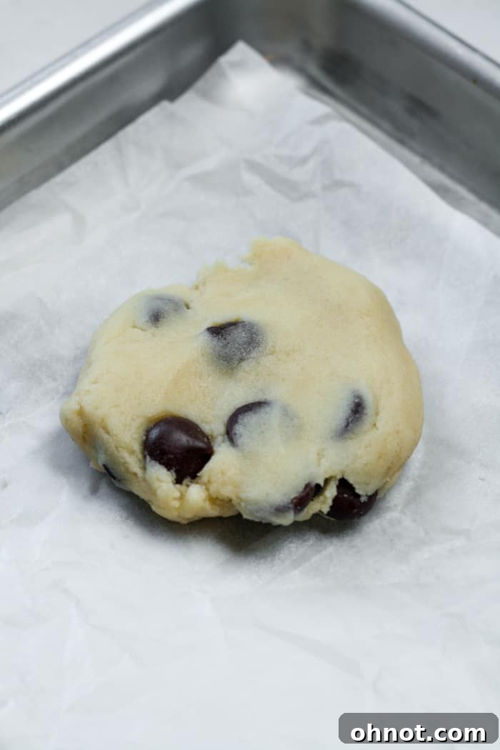 Flattened piece of cookie dough ready for caramel