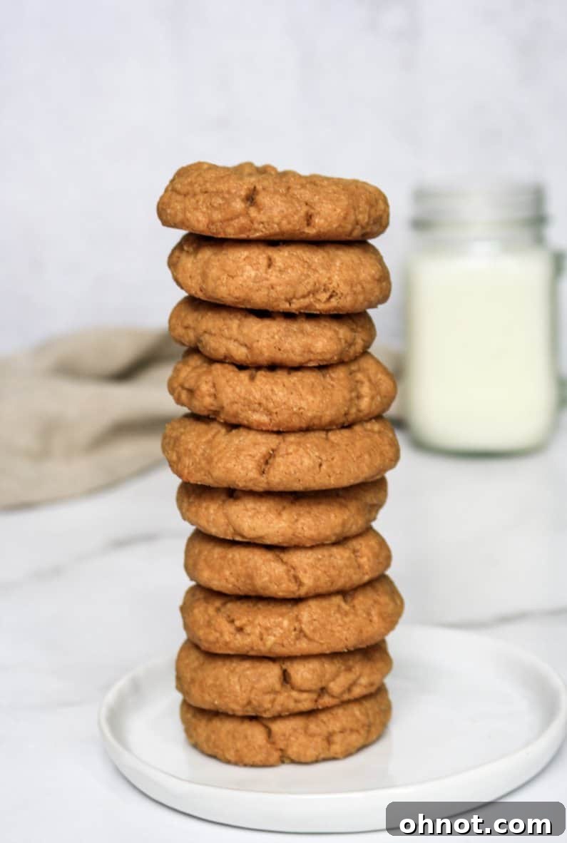 A stack of perfectly baked 3-ingredient paleo cookies on a cooling rack, ready to be enjoyed.
