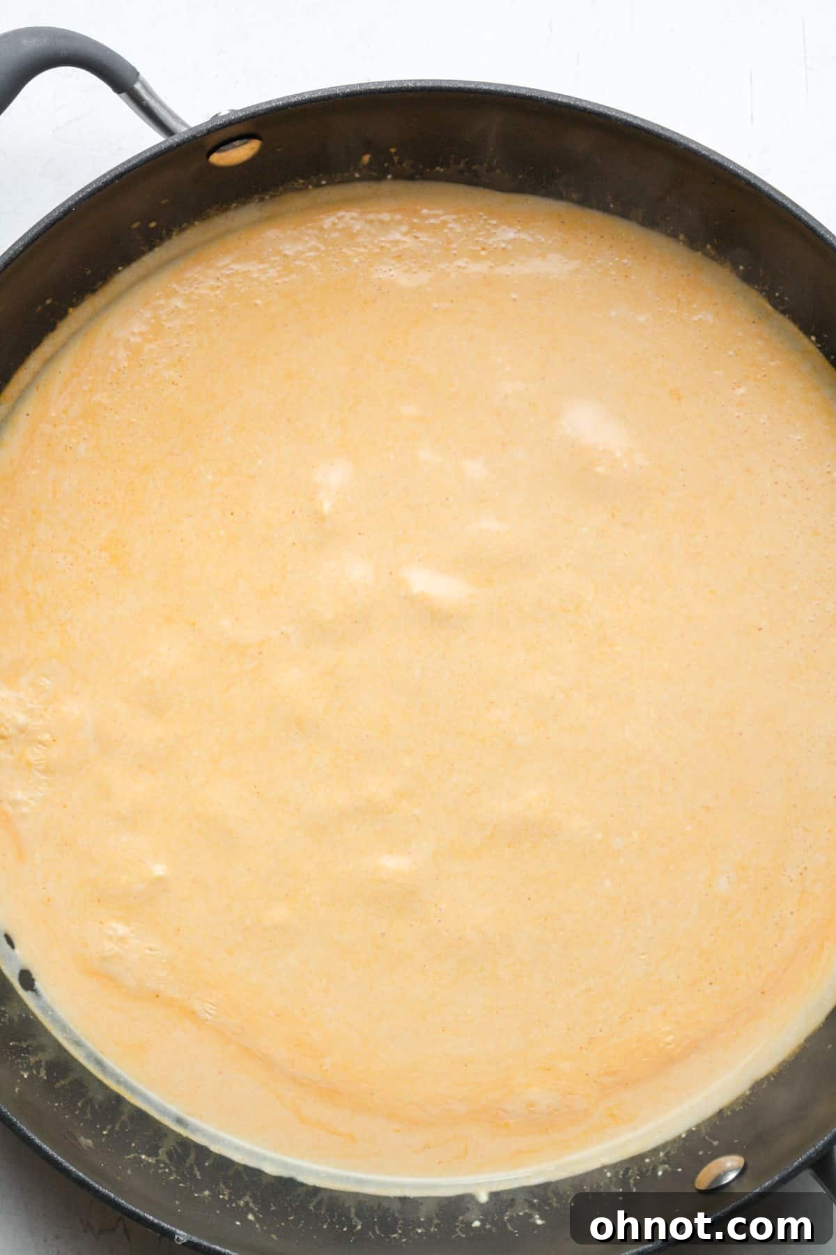Creamy orange sauce in skillet