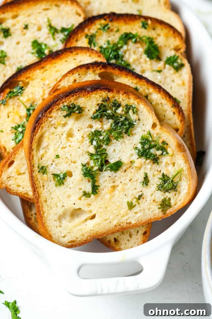 Slices of perfectly golden gluten-free garlic bread, ready to be enjoyed.