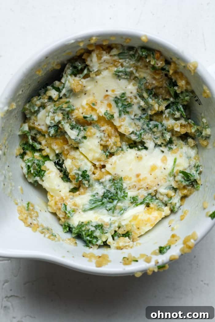 A bowl of freshly mixed garlic herb butter, ready to be spread.