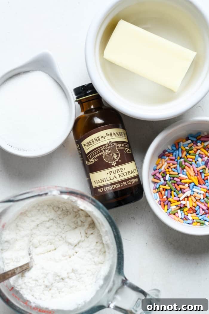 A selection of ingredients including flour, butter, sugar, and sprinkles, ready for mixing.