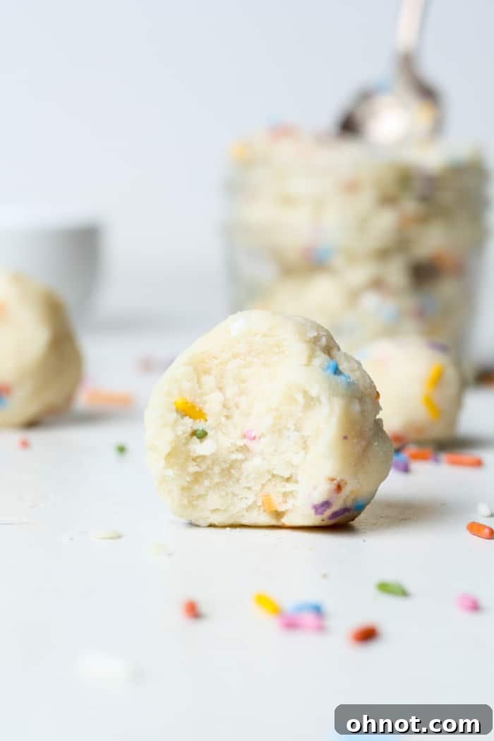 Small, perfectly scooped bites of edible sugar cookie dough, ready to enjoy.