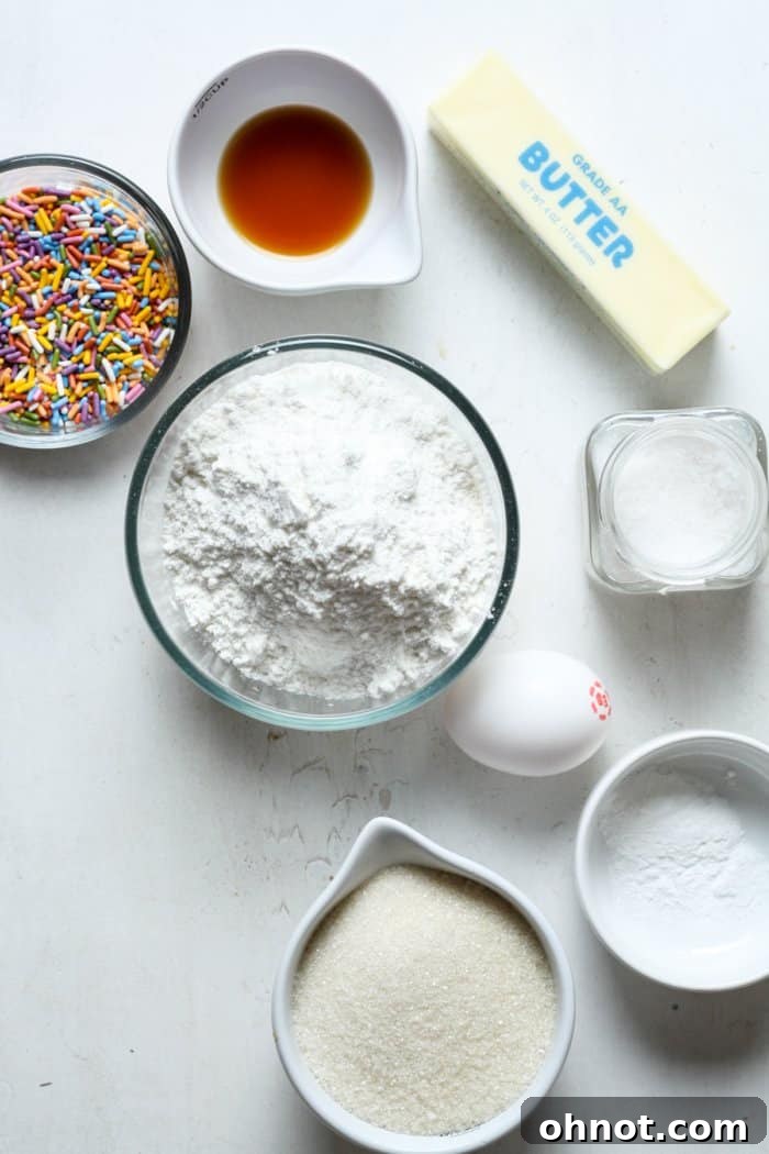 Close-up shot of various baking ingredients, including flour, sugar, and colorful sprinkles, arranged neatly.