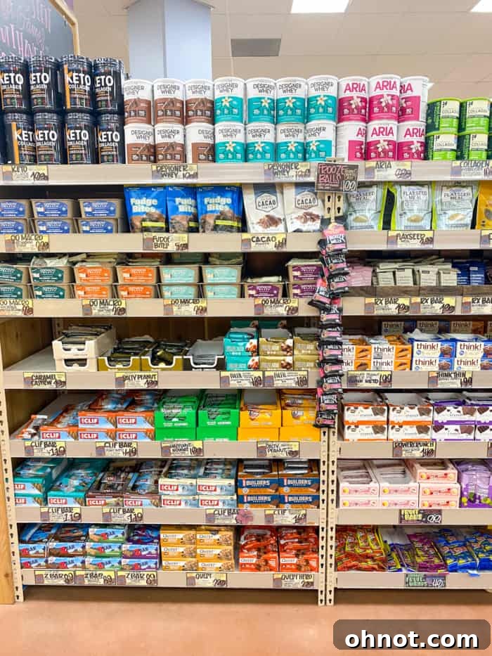 A variety of protein bars displayed in a Trader Joe's store, many of which are gluten-free options.