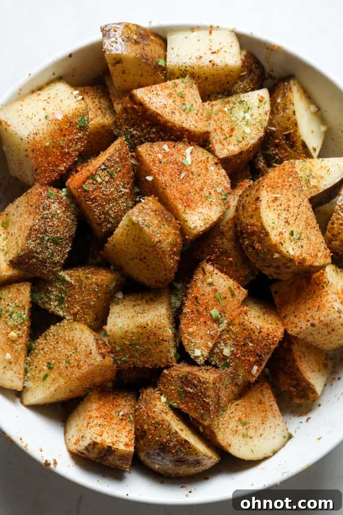 Seasoned potato cubes in a mixing bowl