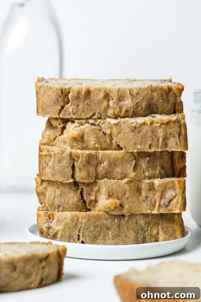 Sugar free banana bread. A beautifully sliced loaf of golden-brown banana bread, showcasing its moist texture and natural ingredients, resting on a rustic wooden board.