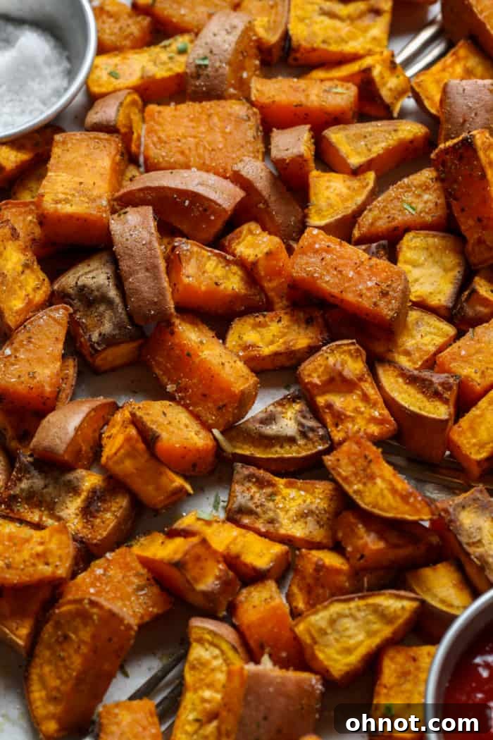 Close-up of crispy sweet potato cubes with a sprinkle of sea salt.