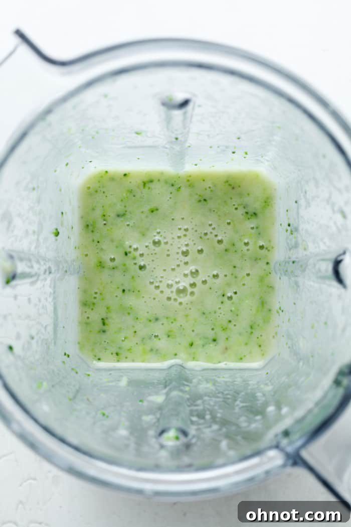 A healthy green smoothie blending smoothly in a high-powered blender.