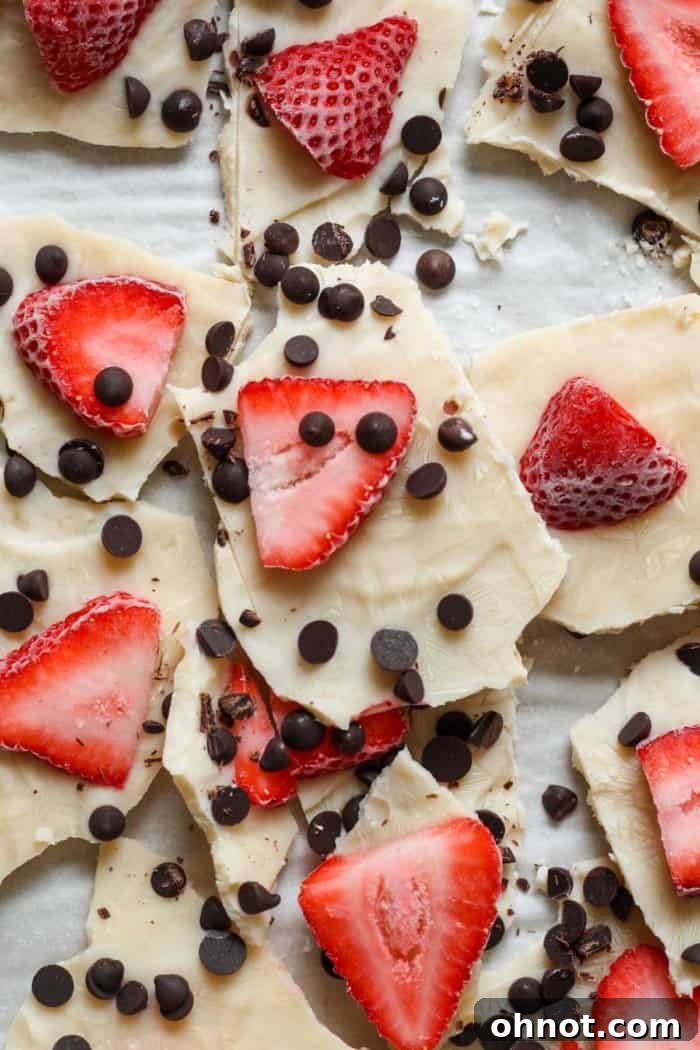 Close-up of fresh sliced strawberries and mini chocolate chips, perfect for yogurt bark toppings.