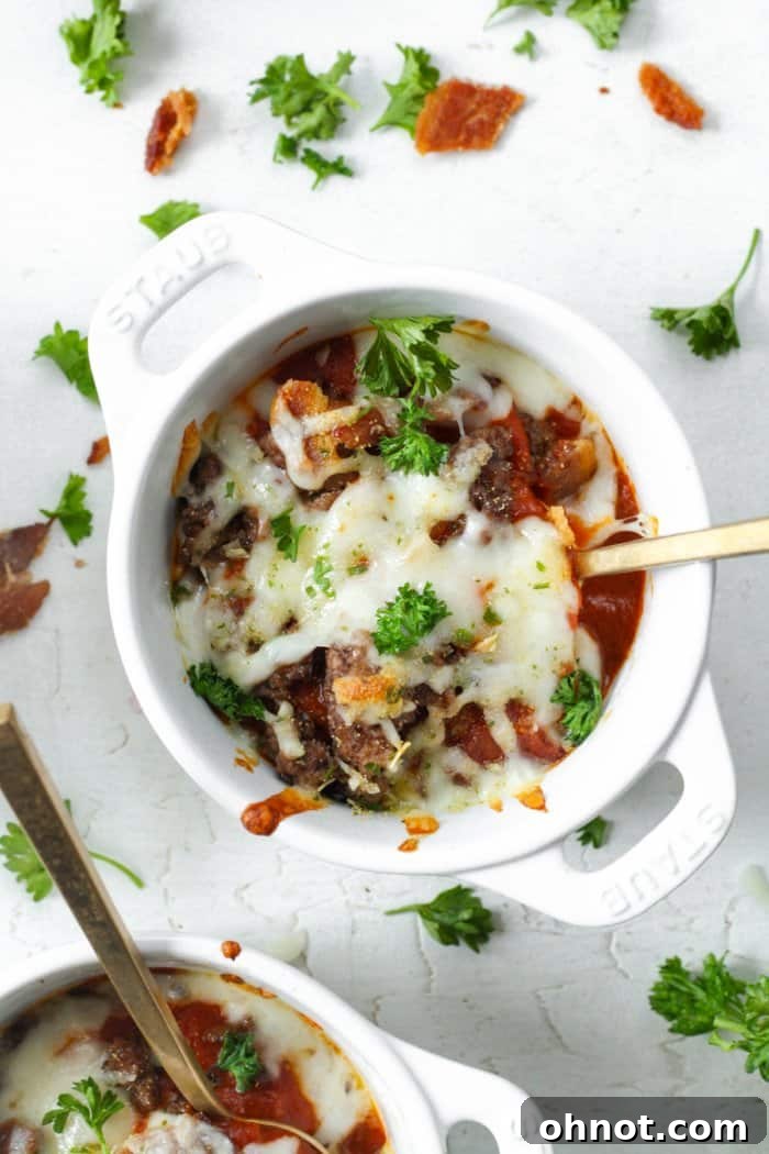 Two freshly baked Keto-friendly pizza bowls, showcasing the rich toppings and melted cheese.