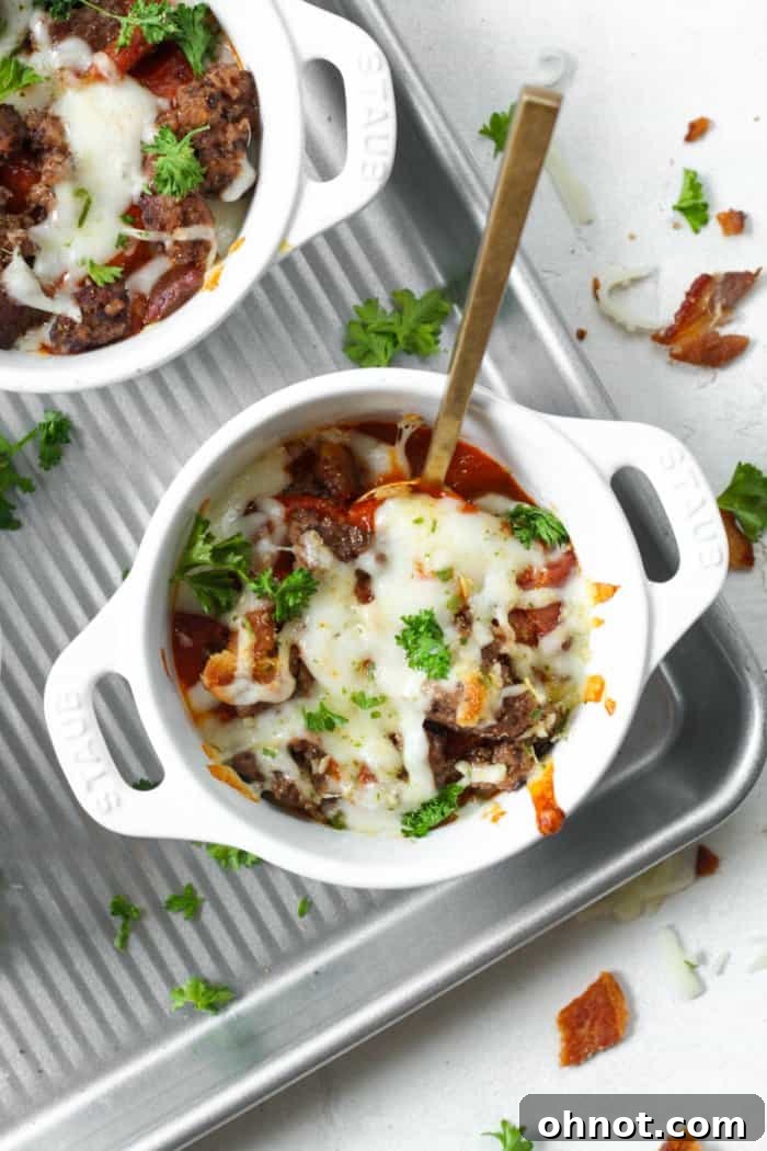 A delicious and healthy pizza in a bowl, showcasing the rich layers of sauce, cheese, and toppings.