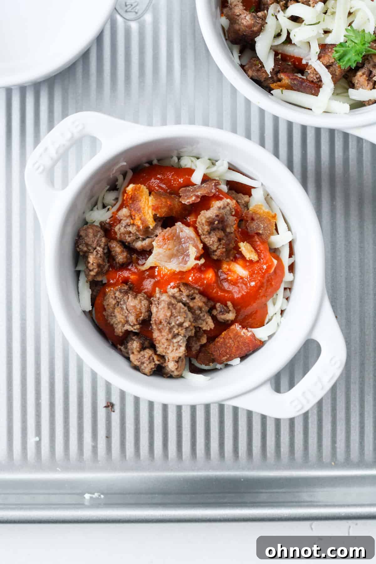 Bowl with a second layer of beef and bacon, showing a hearty build-up of ingredients.