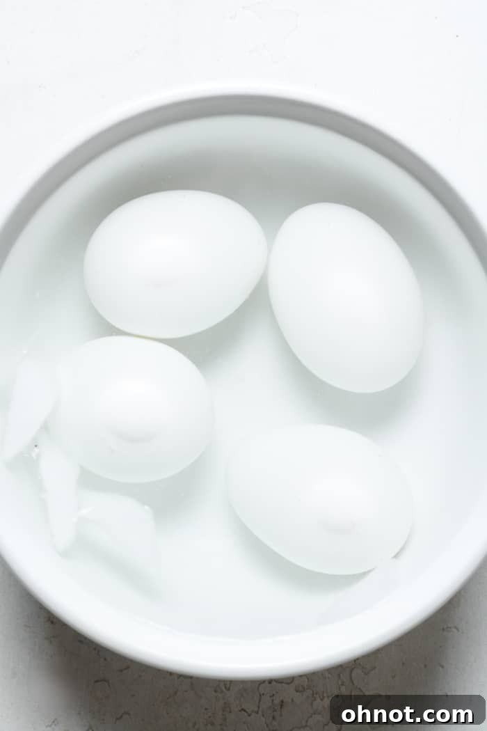 Eggs submerged in an ice bath in a mixing bowl.