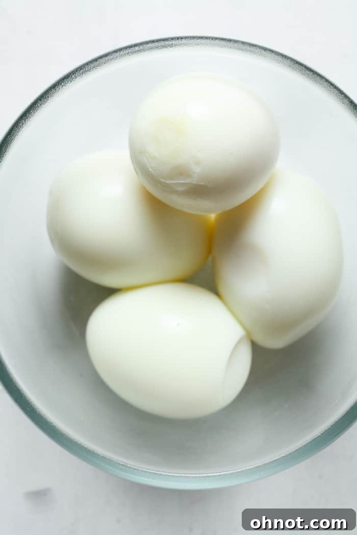 Peeled hard boiled eggs in a bowl, ready to be served.