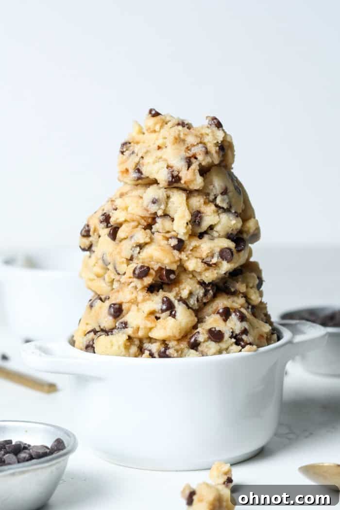 Vegan chocolate chip cookie dough in a white bowl, ready to be eaten.