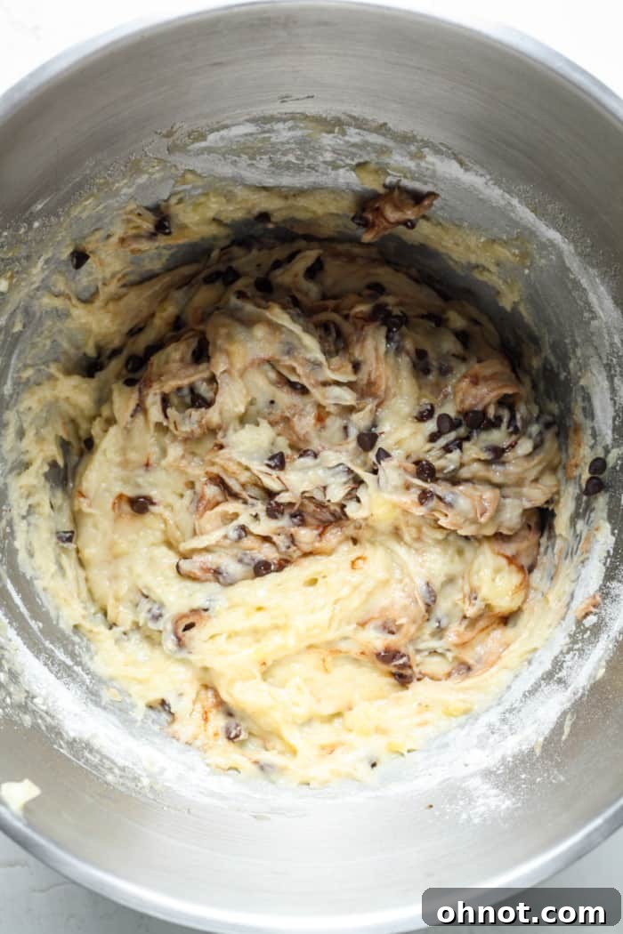 Muffin batter with chocolate chips and melted chocolate gently swirled in, creating a marbled effect.