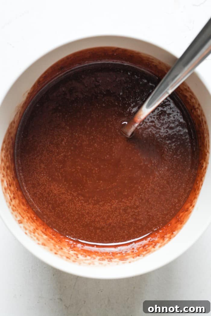 Smooth, melted dairy-free chocolate and coconut oil mixture in a bowl.