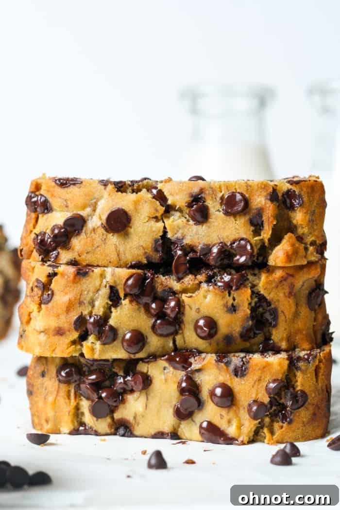 A perfectly baked loaf of golden-brown dairy-free banana bread, sliced to reveal its moist interior.