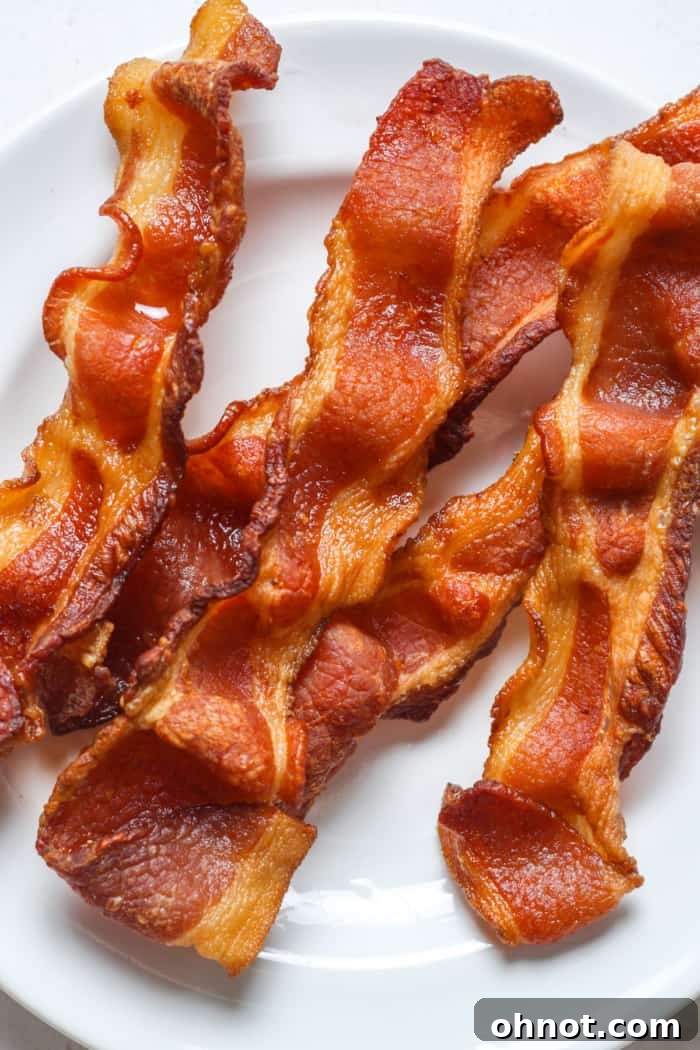 Close-up of perfectly cooked and crispy pork bacon slices.