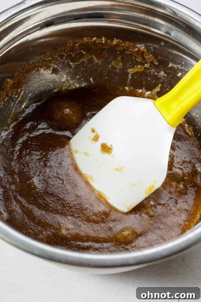 Caramelized sugar mixture with egg and vanilla extract in a bowl.