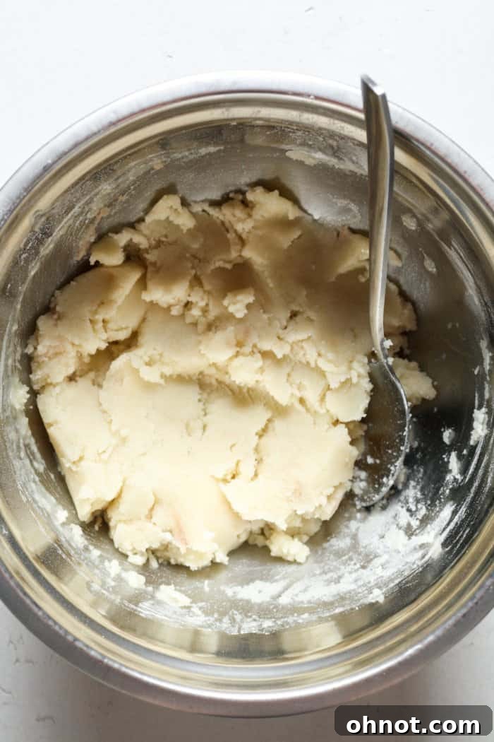 Shortbread crust mixture in a mixing bowl, ready to be pressed into the pan.
