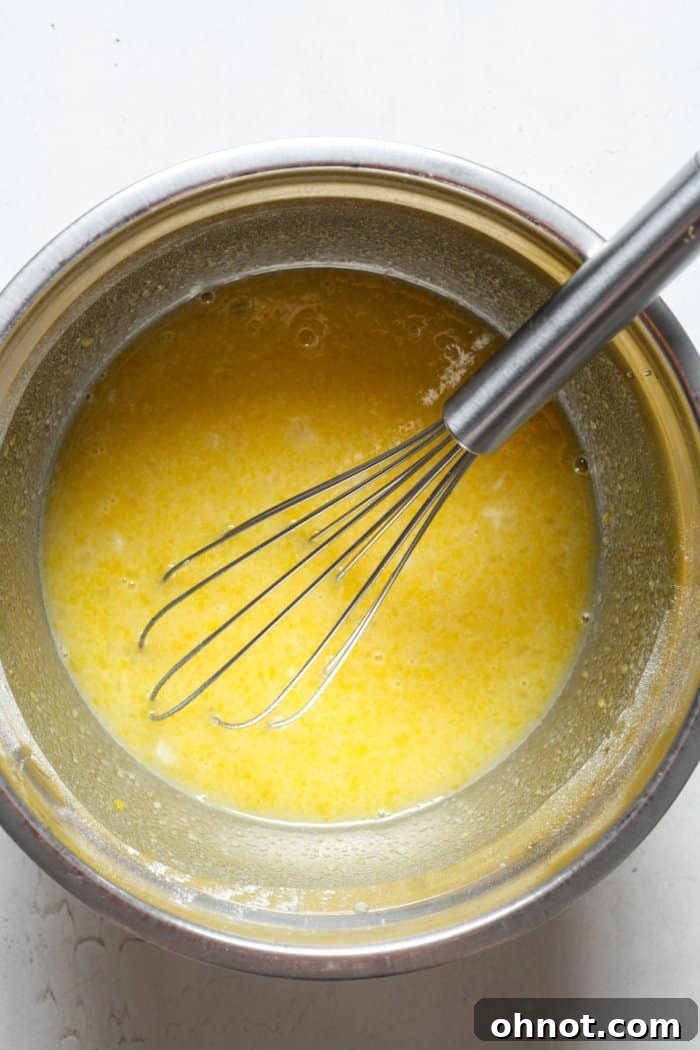 Creamy lemon curd filling in a bowl, smooth and ready to be poured.