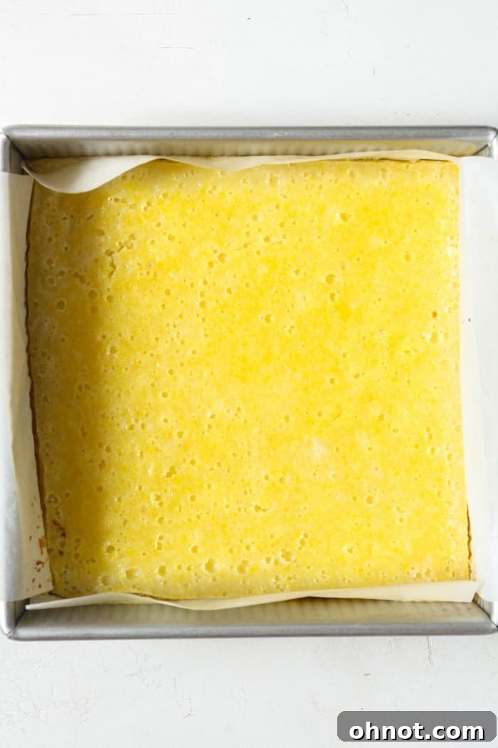 Baked gluten-free lemon squares in the pan, fresh out of the oven.