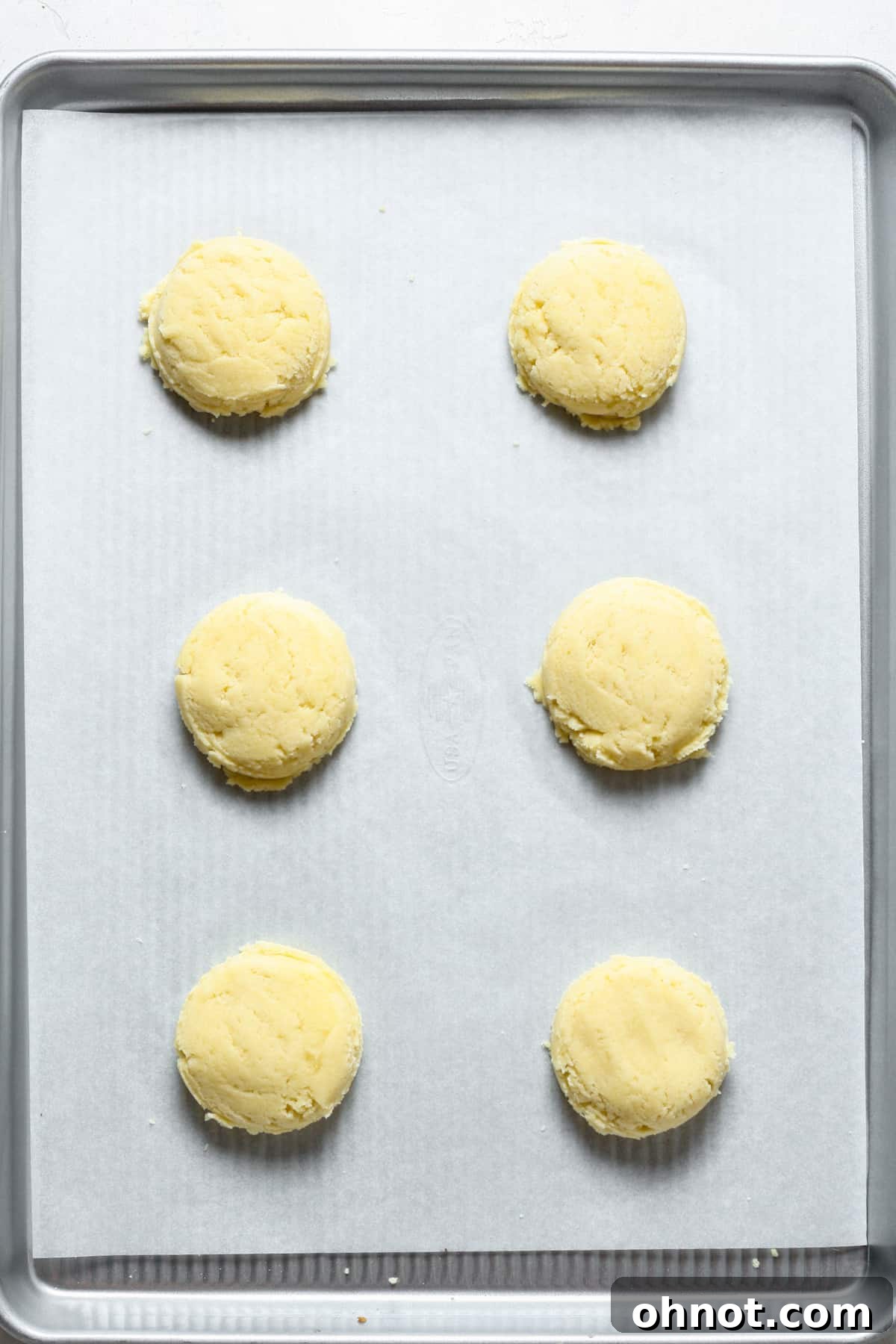 Flat balls of dough.