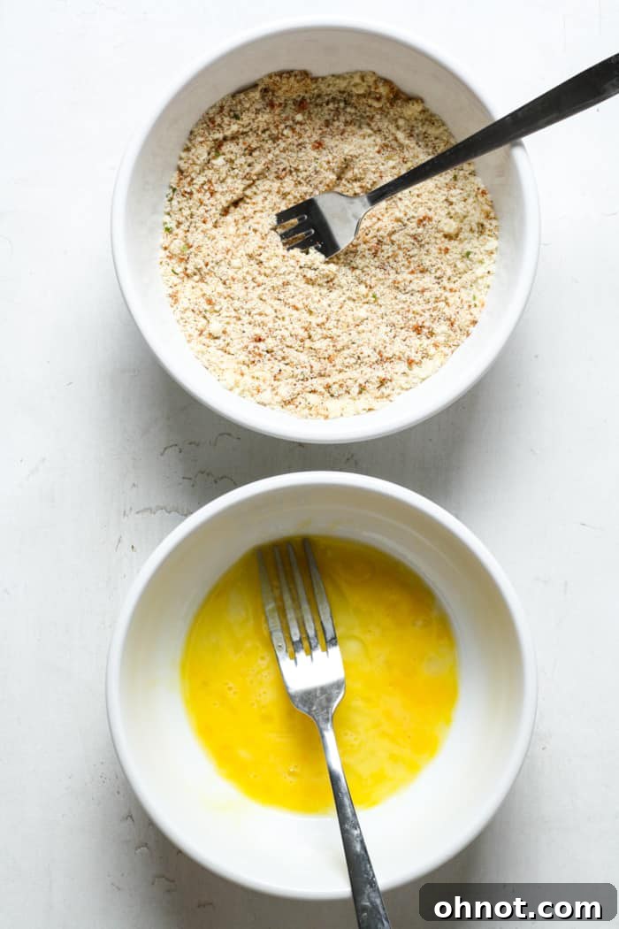 Two shallow bowls, one with whisked eggs and another with dry spice and almond flour mixture.